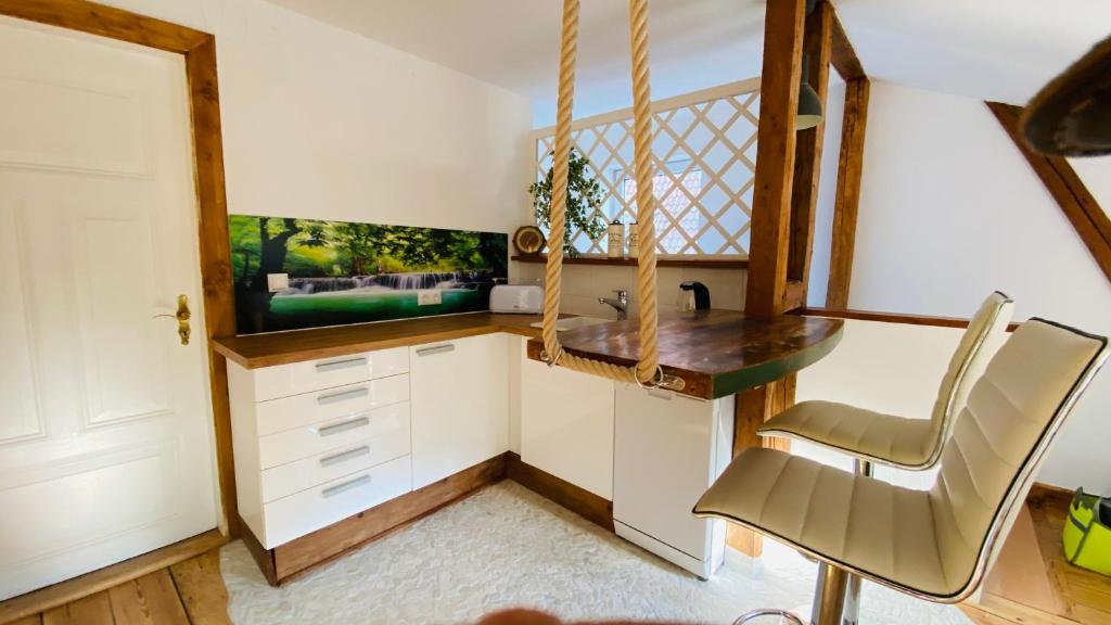 a small kitchen with a desk and a window at An Bord in Bad Schwartau