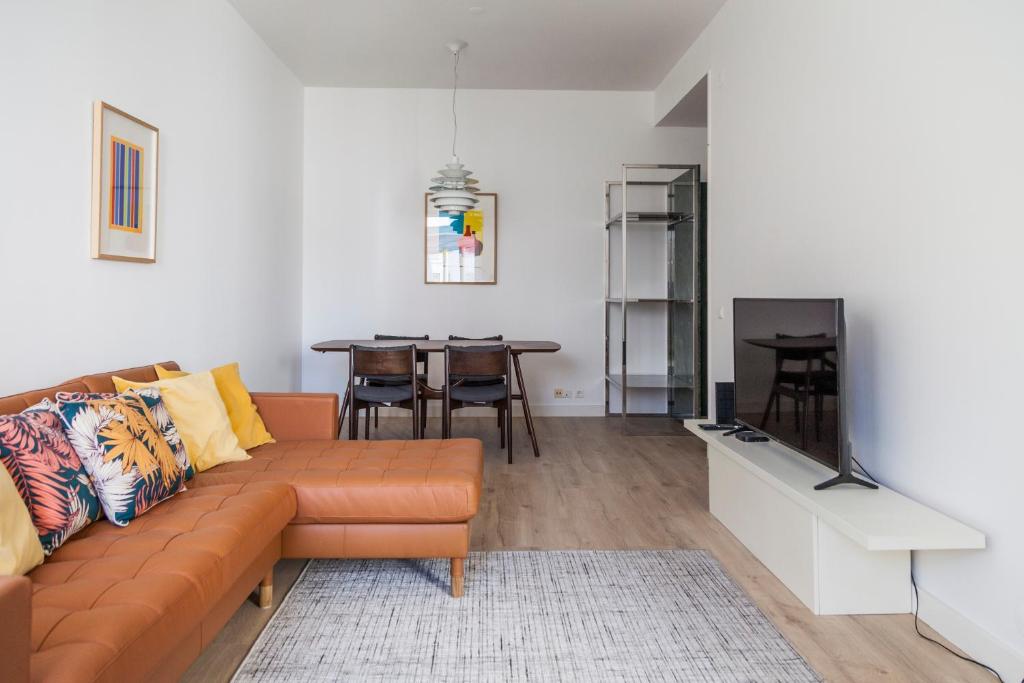 ein Wohnzimmer mit einem Sofa und einem Tisch in der Unterkunft Classy 2BDR Apartment in Downtown by LovelyStay in Lissabon
