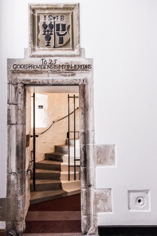 a staircase in a building with a picture on the wall at Ballygally Castle in Larne