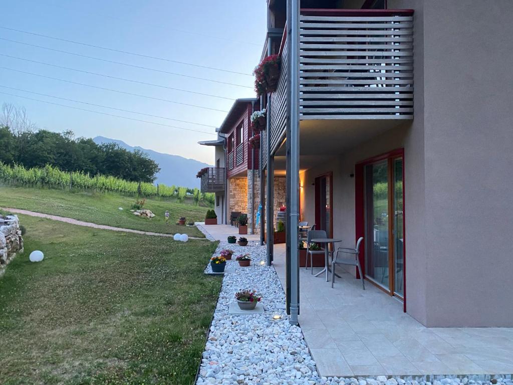 a house with a patio with a table and chairs at Agritur Verderame in Trento