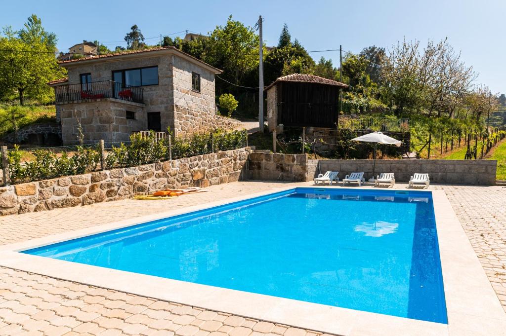 a swimming pool in front of a house at Idyllic Villa in Fornos + Pool! in Fornos