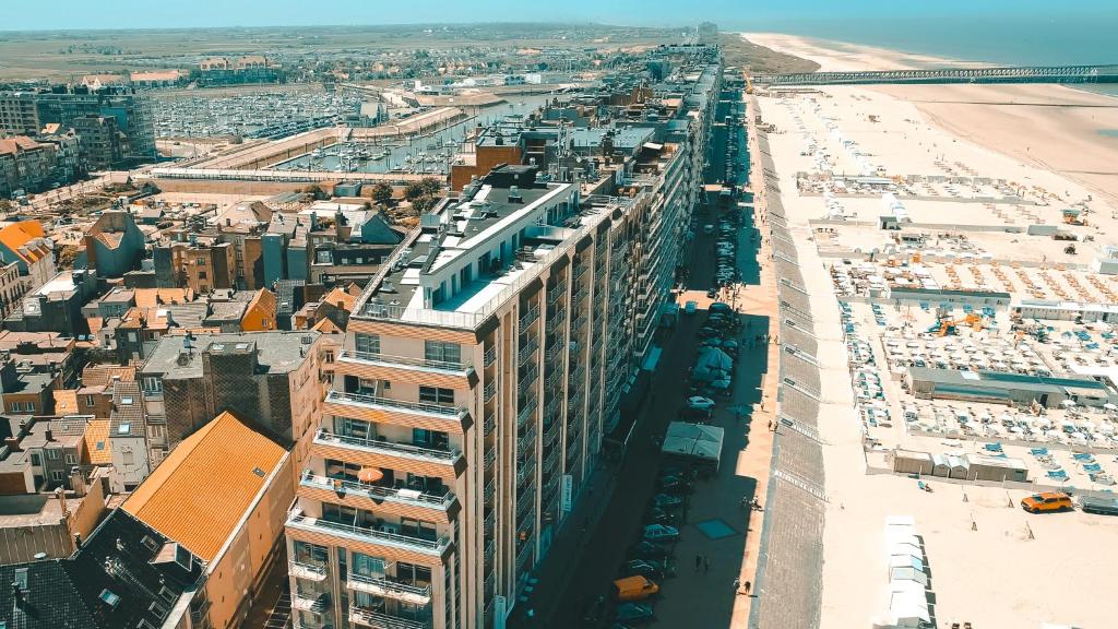 an aerial view of a tall building next to a beach at Holiday Suites Blankenberge in Blankenberge