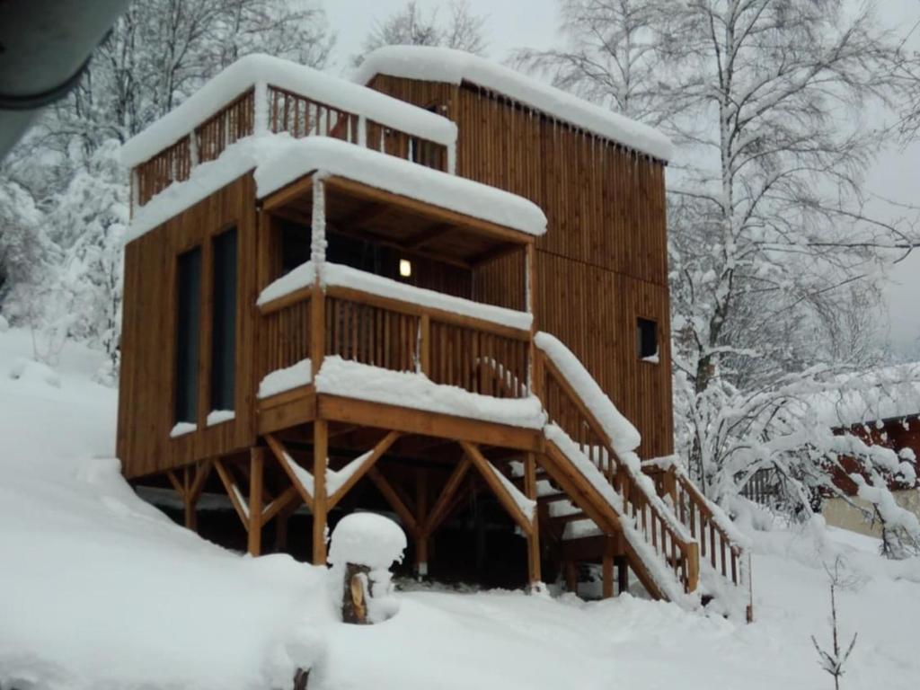 a log cabin in the snow with snow at Gîte le Pieraline in Ventron