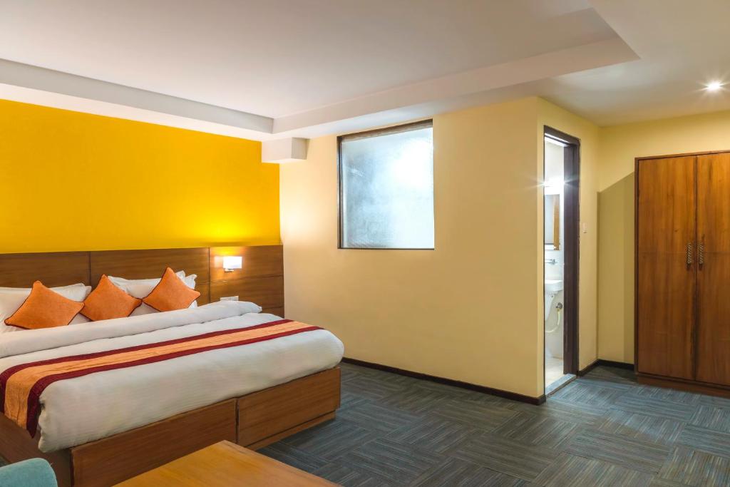 Voodi või voodid majutusasutuse Hotel Ananda Pashupati toas