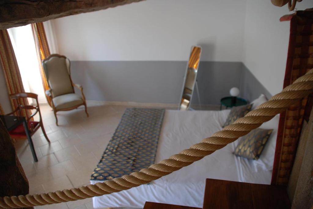 a bedroom with a bed with a rope around it at Champ Fleuri in Angoulême