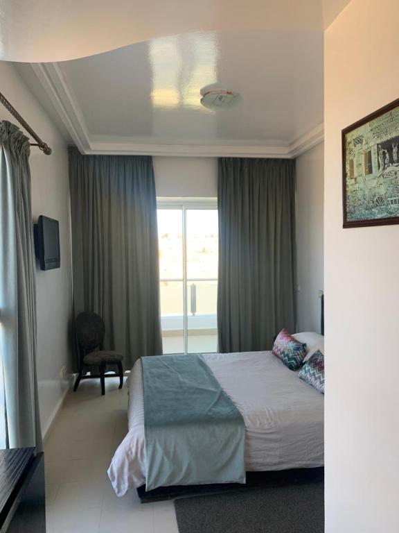 a hotel room with a bed and a window at Auberge Oualidia Dream in Oualidia