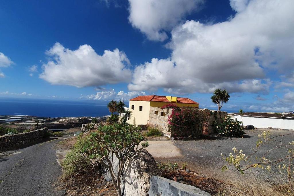 a house on the side of a road near the ocean at Impeccable 2-Bed House in Guia de Isora in Guía de Isora