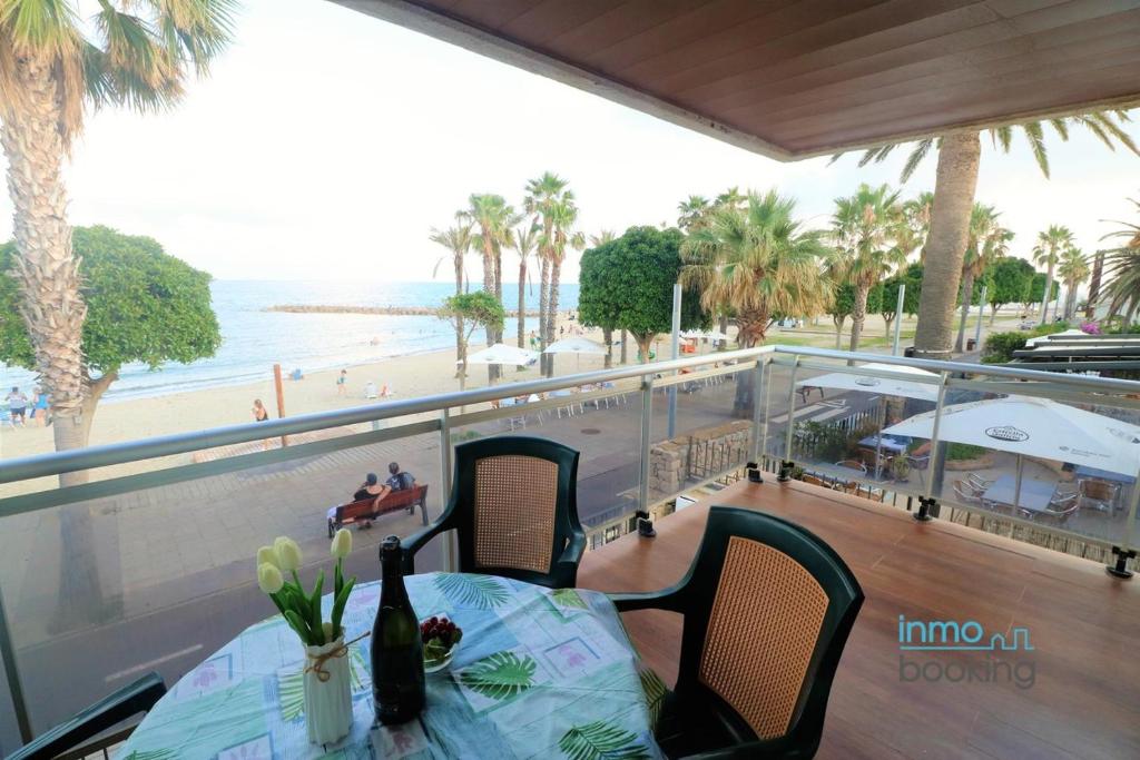 a table and chairs with a view of the beach at Sun Beach Mediterrani, en frente del Mar in Cambrils
