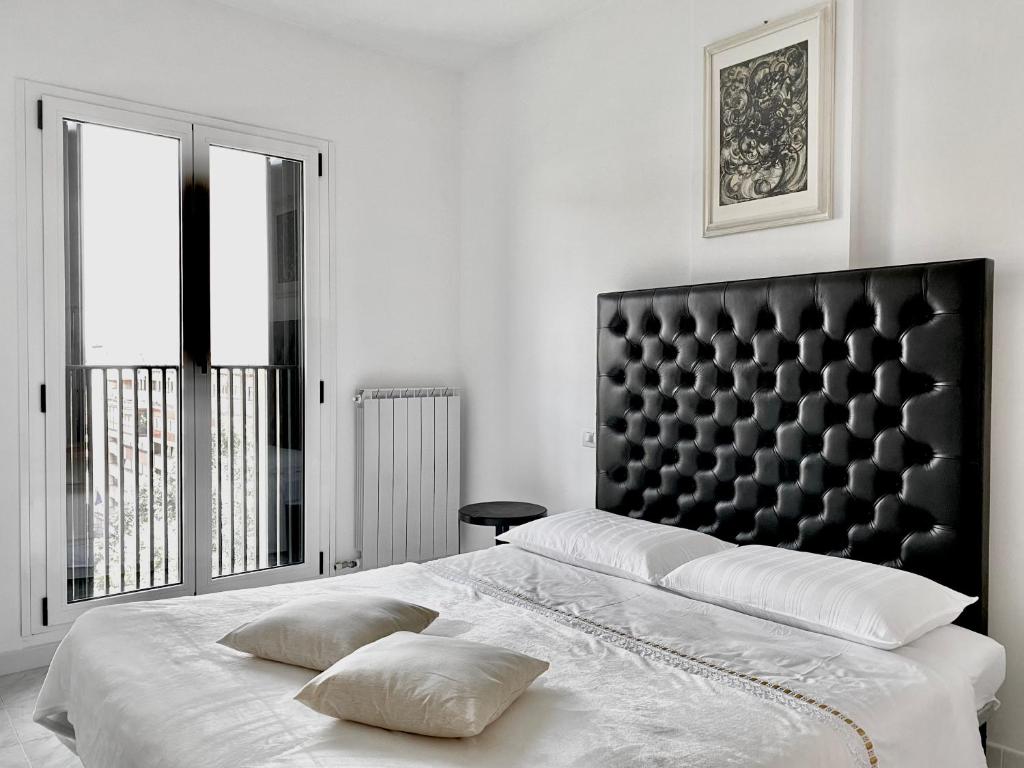 a bedroom with a large bed with a black headboard at B&B Blessed apartment in Perugia