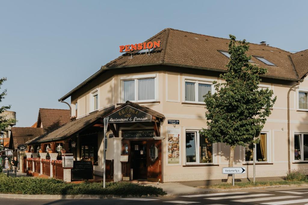 a building on the corner of a street at Korona Pension and Restaurant in Hévíz