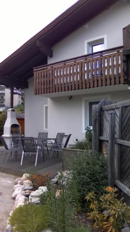 ein Haus mit einer Terrasse und Liegestühlen in der Unterkunft Ferienhaus Fux in Bad Mitterndorf