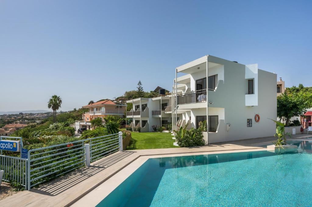 a villa with a swimming pool and a house at Hermes Sea View in Stalos