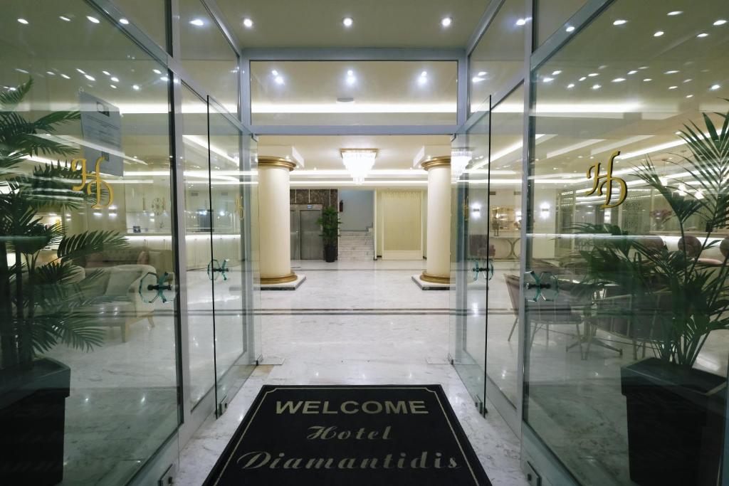 a lobby with glass doors and a welcome sign at Hotel Diamantidis in Mirina