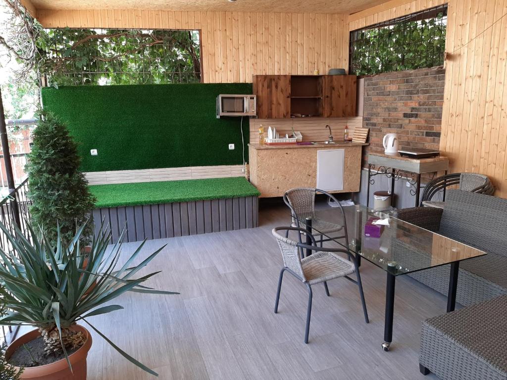 a patio with a table and chairs and a kitchen at Shara Talyan 8/2 Guest House in Yerevan