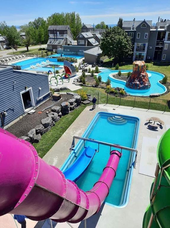 a large water park with a water slide at Condo avec parc aquatique ! in Beaupré