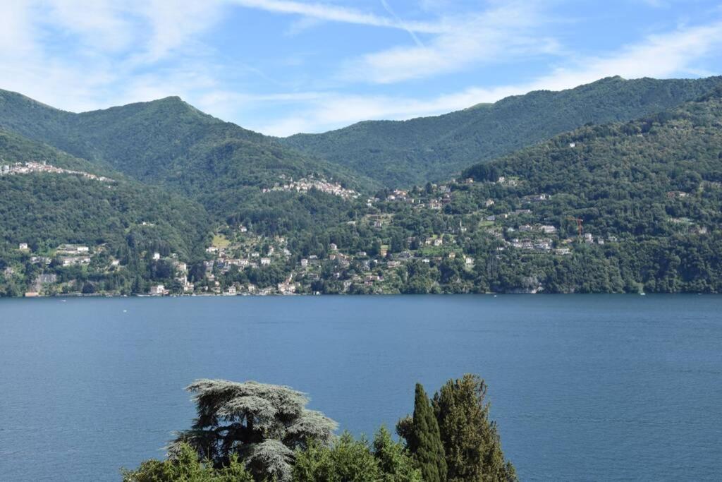 a view of a lake with mountains in the background at La Resilienza, apartment with view, Carate Urio in Carate Urio