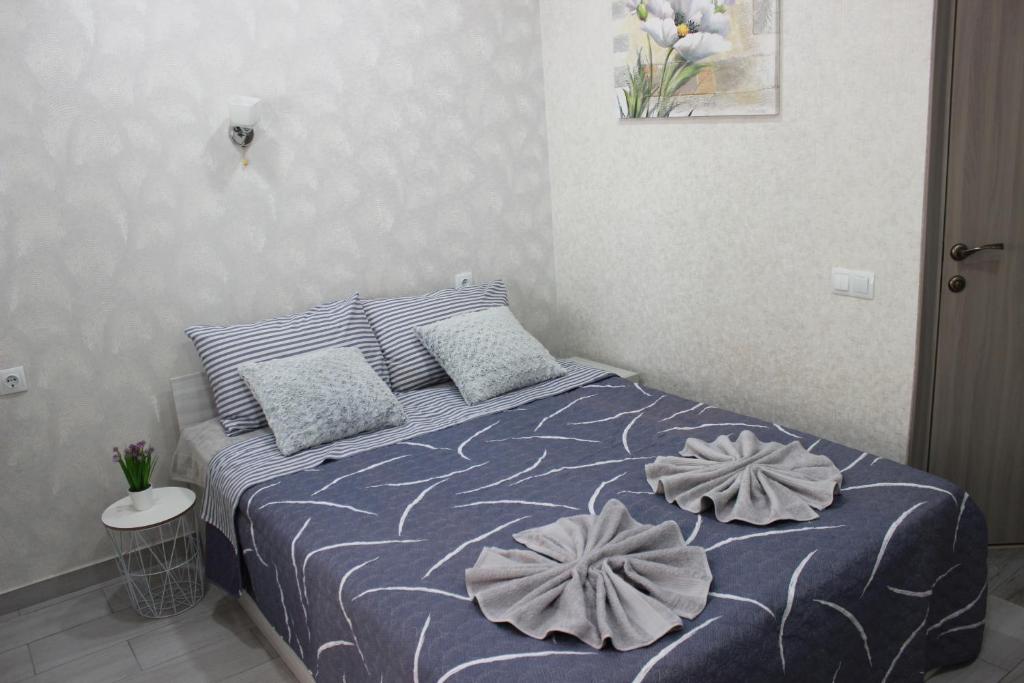 a bedroom with a bed with two pillows on it at Apartments in Kharkiv in Kharkiv