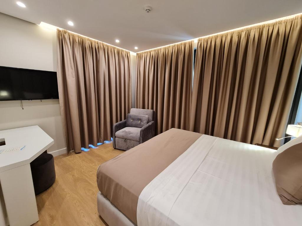 Postel nebo postele na pokoji v ubytování Hotel Aross