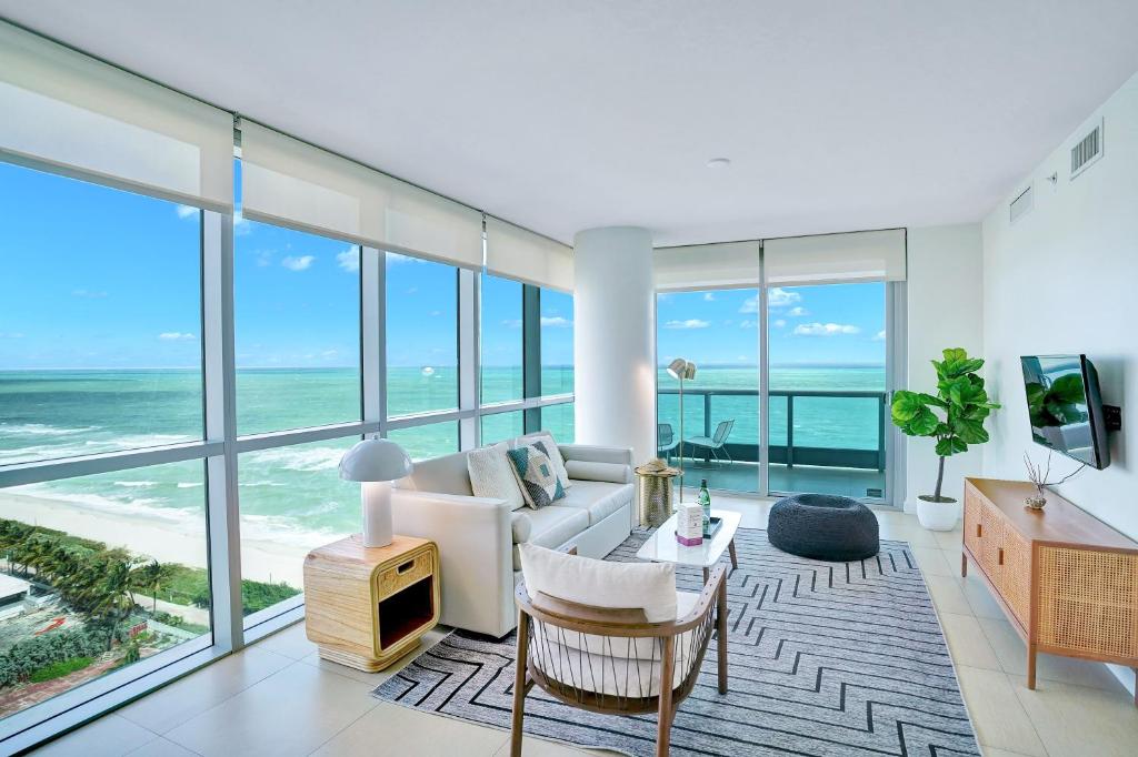 a living room with a view of the ocean at Dharma Home Suites Miami Beach at Monte Carlo in Miami Beach