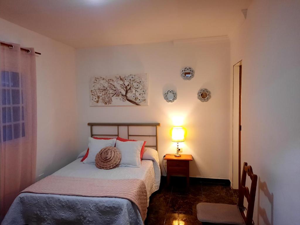 a bedroom with two beds and a lamp on a table at Casa Mary in Valles de Ortega