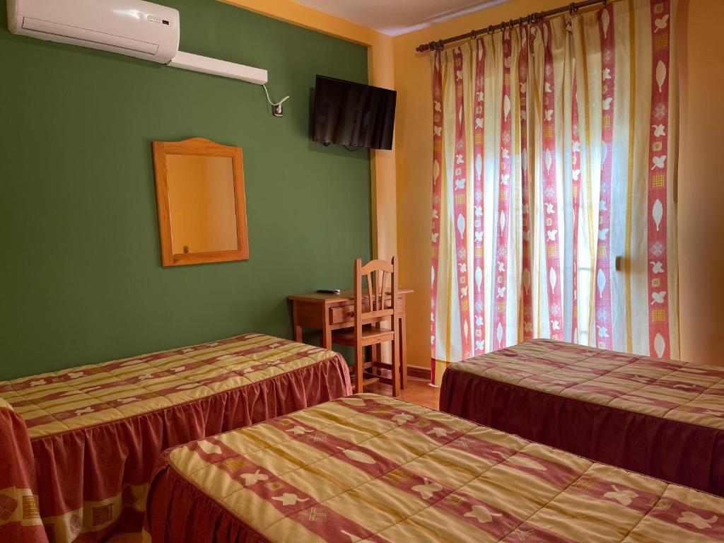 Postel nebo postele na pokoji v ubytování Quéntar Hotel Rural
