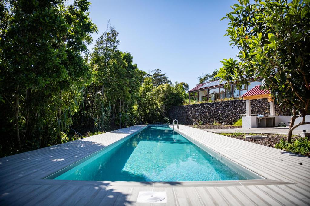 a swimming pool in the backyard of a house at Quinta do Abacate - Glamping Park in Angra do Heroísmo