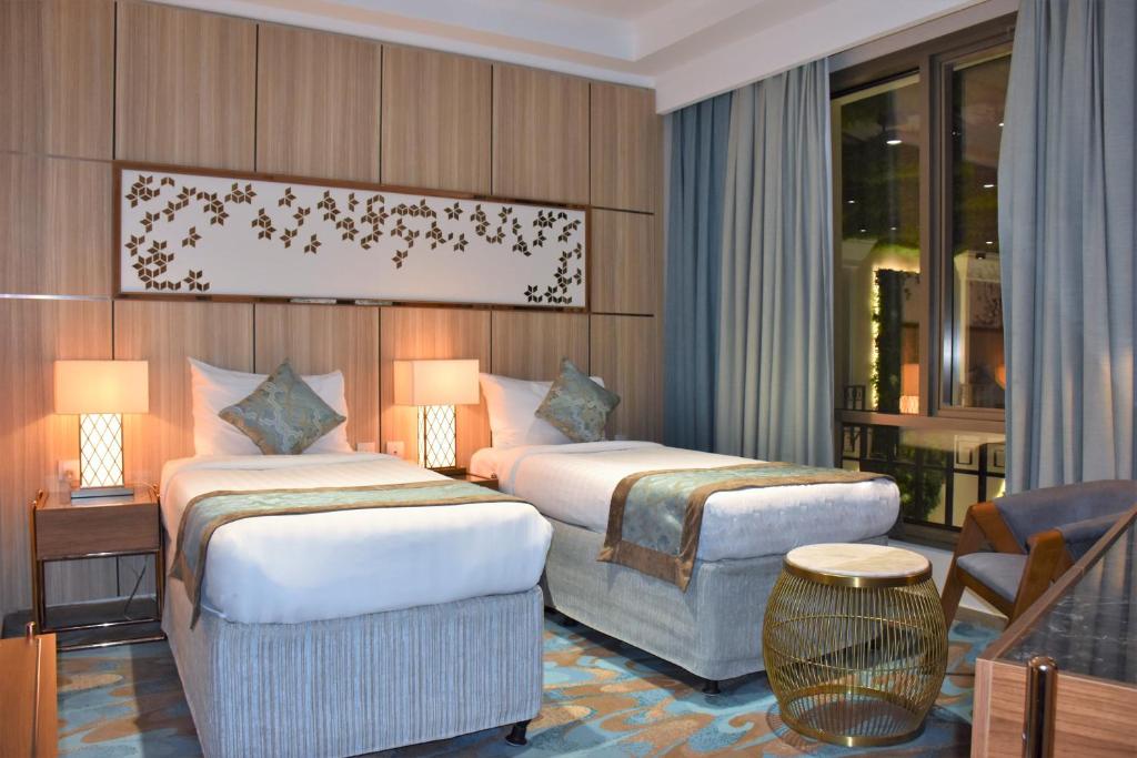Postel nebo postele na pokoji v ubytování Midan Hotel & Suites Al Aziziya
