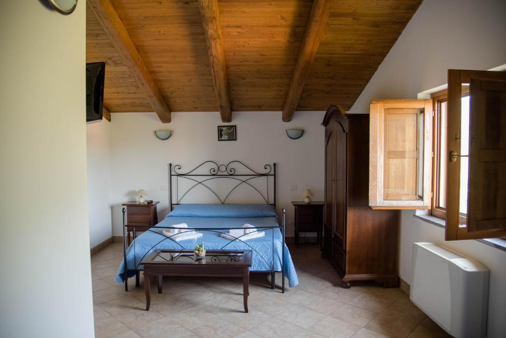 a bedroom with a bed and a wooden ceiling at Antico Sogno in Alfano