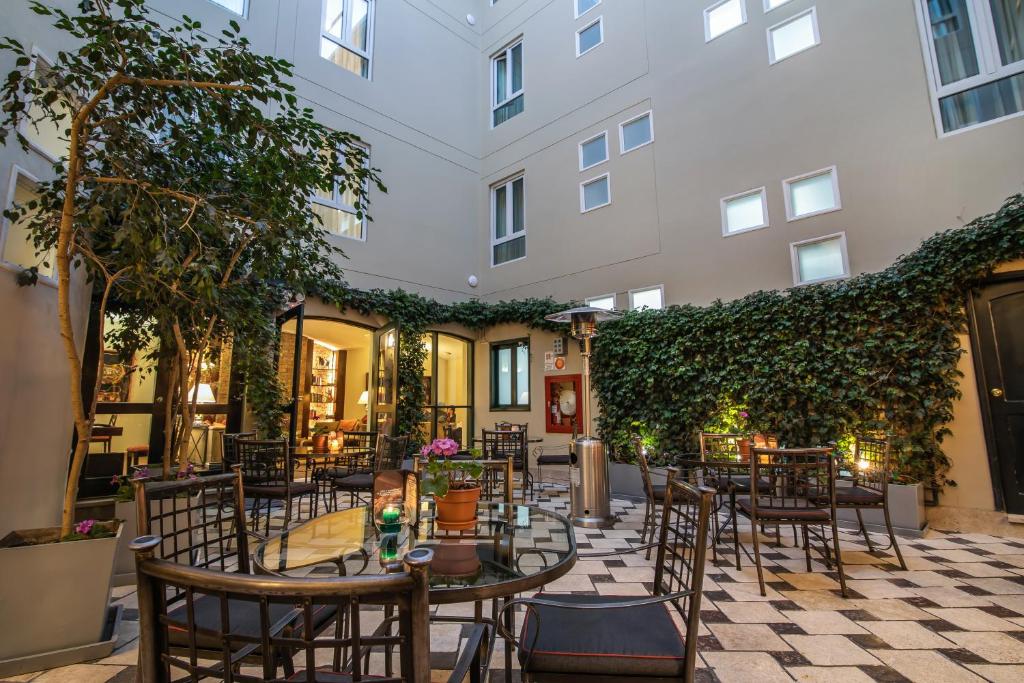 a patio with tables and chairs in a building at LP Los Portales Hotel Cusco in Cusco