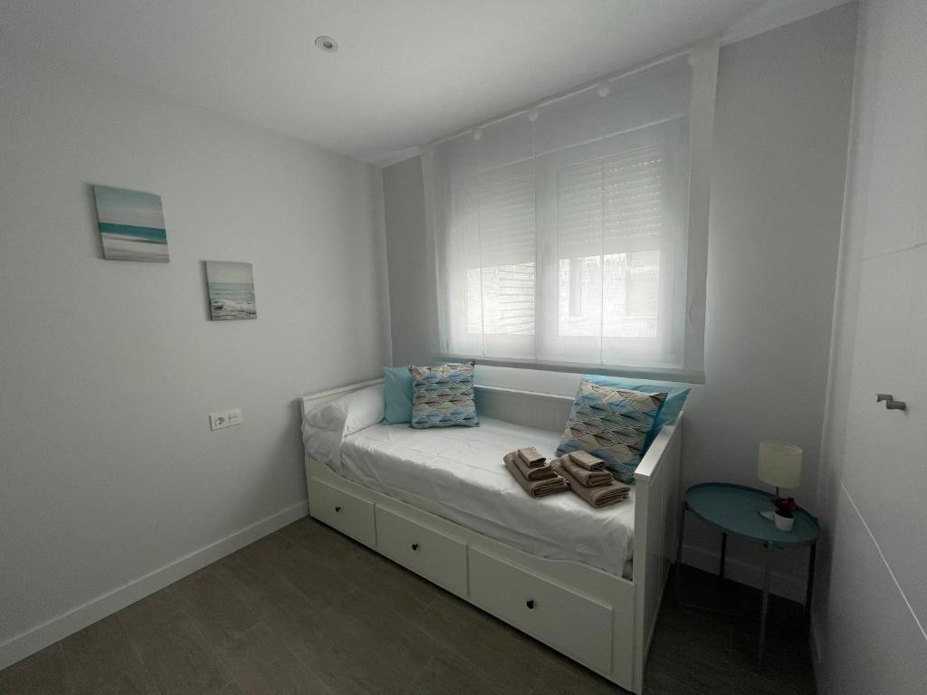 Postel nebo postele na pokoji v ubytování Amazing Duna Beach Seafront Apartament