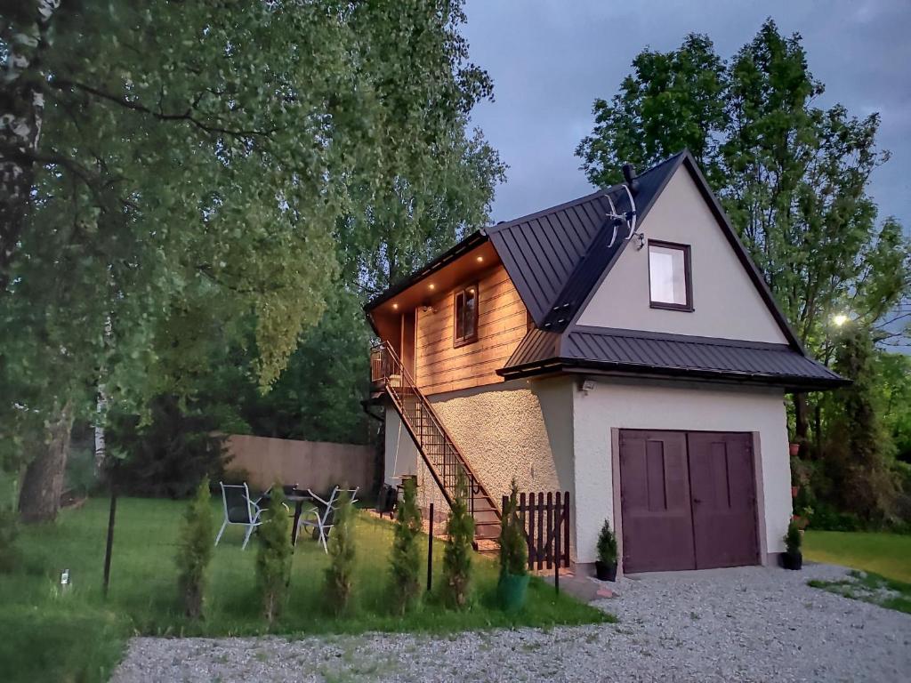 a tiny house with a dark roof at Domek pod Brzozami - zniżki na Termy Bania! in Czarna Góra