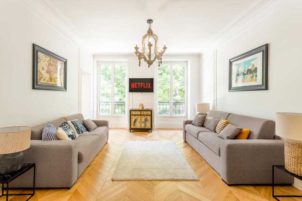 a living room with two couches and a fireplace at La Résidence du Sénateur in Paris