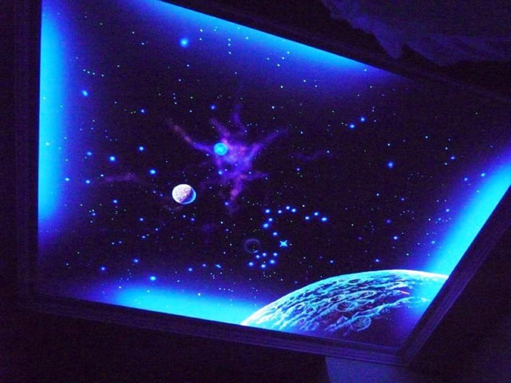 a tv screen with a planet and a universe at Hai Yang Feng Qing Homestay in Hualien City