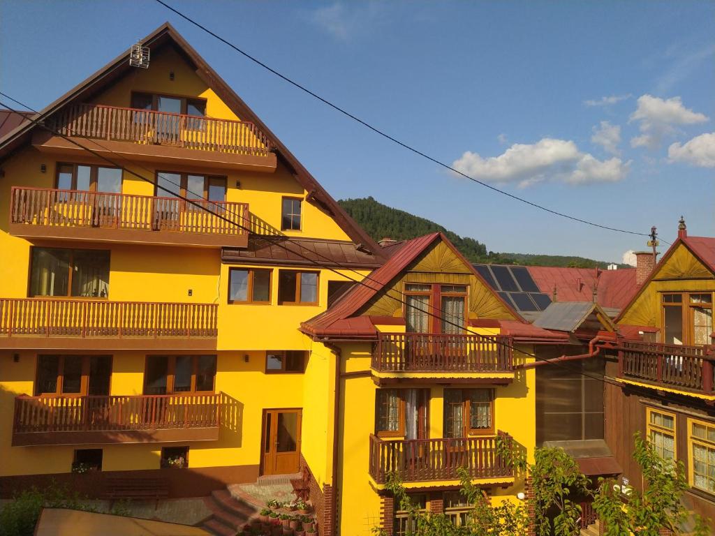 a yellow building with balconies on the side of it at Gackówka in Szczawnica