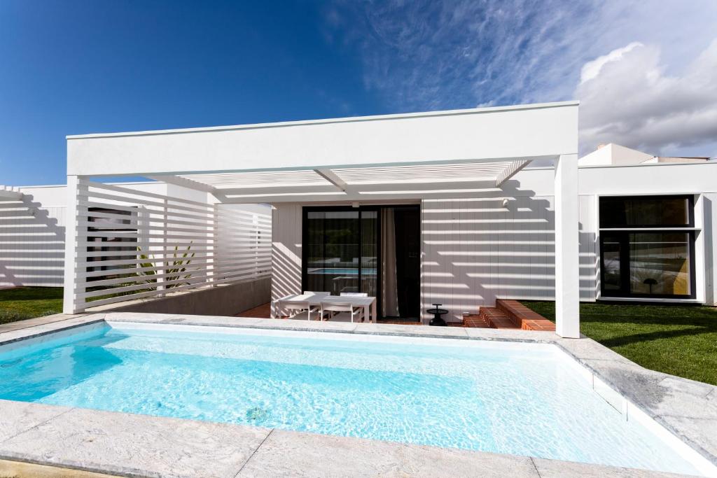 a swimming pool in front of a villa at Ericeira Prime Villas in Ericeira