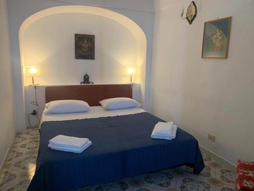 a bedroom with a bed with two towels on it at Villa Pina in Praiano