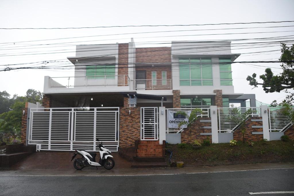 a scooter parked in front of a house at La Casa Vacanze PH Private villa w/ swimming pool in Batangas City