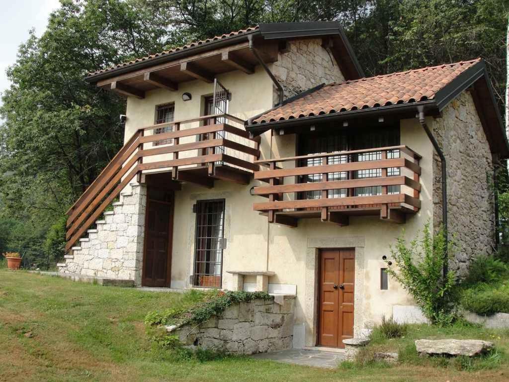 a house with a balcony on the side of it at Holiday home in Madonna Del Sasso 22866 in Madonna del Sasso