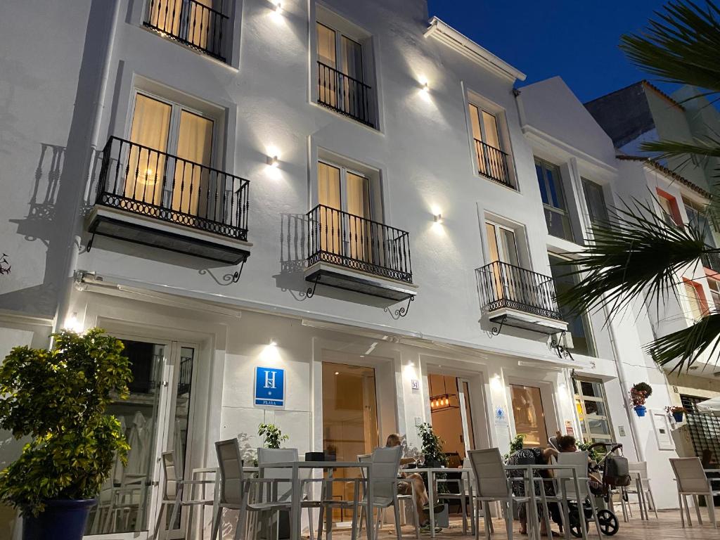 a white building with tables and chairs in front of it at The Old Town Boutique Hotel - Adults Only in Estepona
