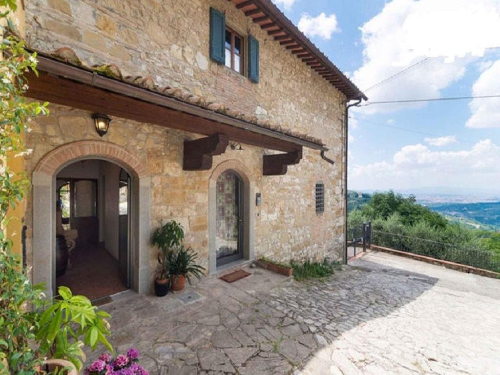 a stone house with a large entrance to it at Apartment in Bagno a Ripoli/Toskana 23871 in Villamagna
