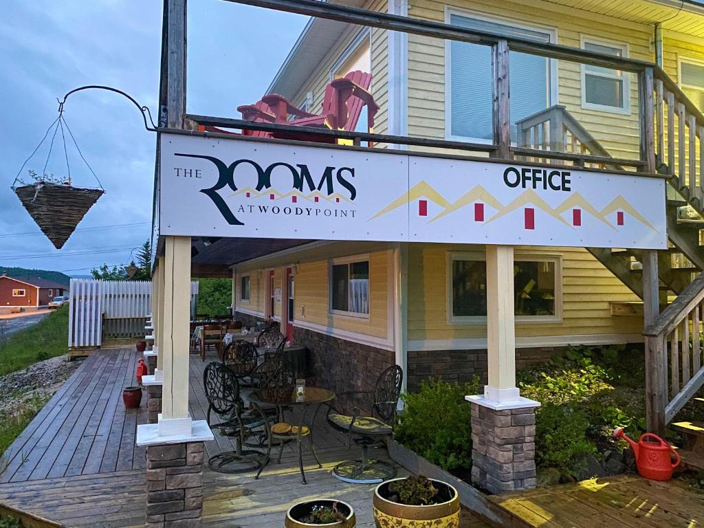 a sign for a restaurant on a deck at The Rooms at Woody Point in Bonne Bay