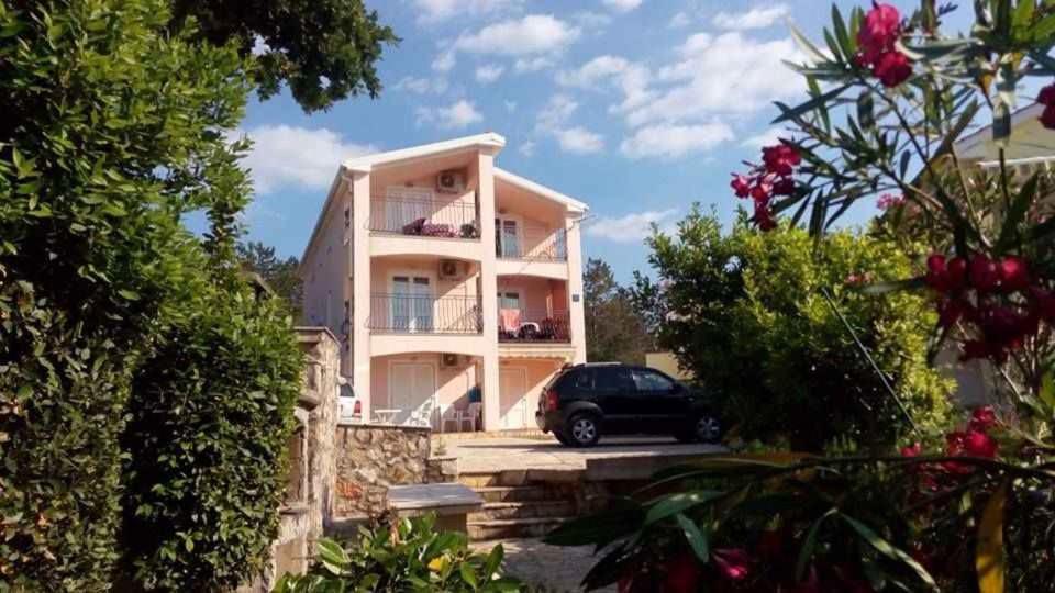 a house with a car parked in front of it at Apartments in Klimno/Insel Krk 12514 in Klimno