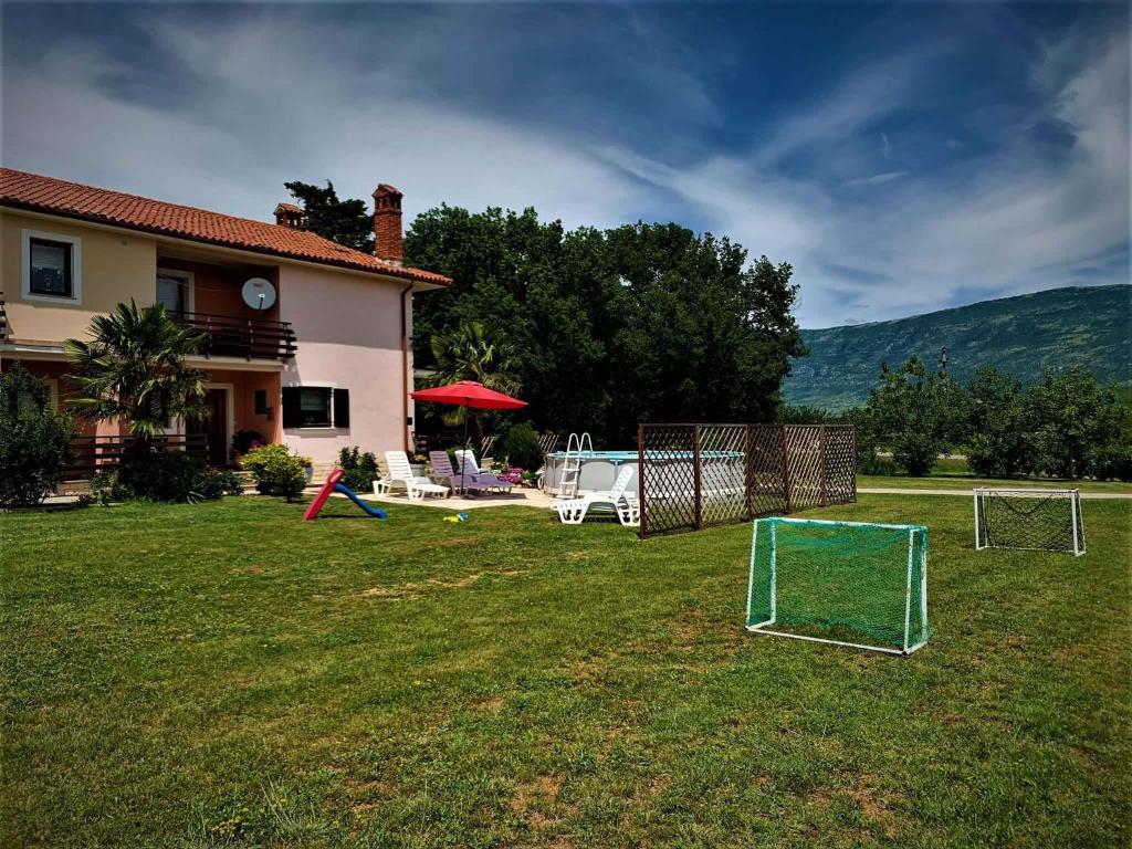 a yard with a soccer goal and a house at Apartment in Krsan 8830 in Kršan