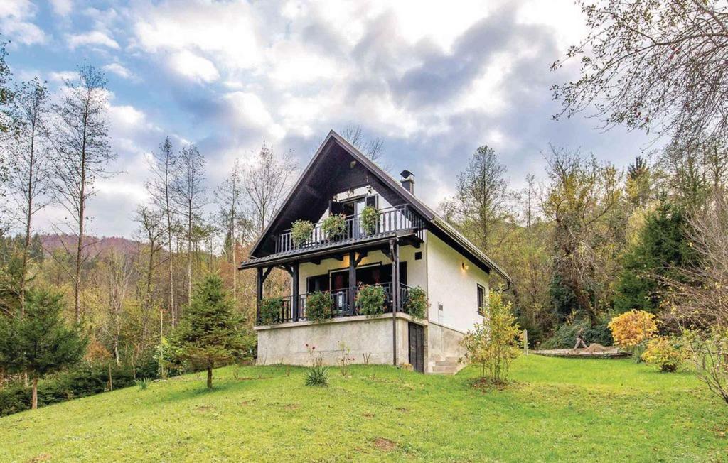 a small house with a balcony on a field at Holiday home in Turke - Gorski Kotar 35160 in Turke