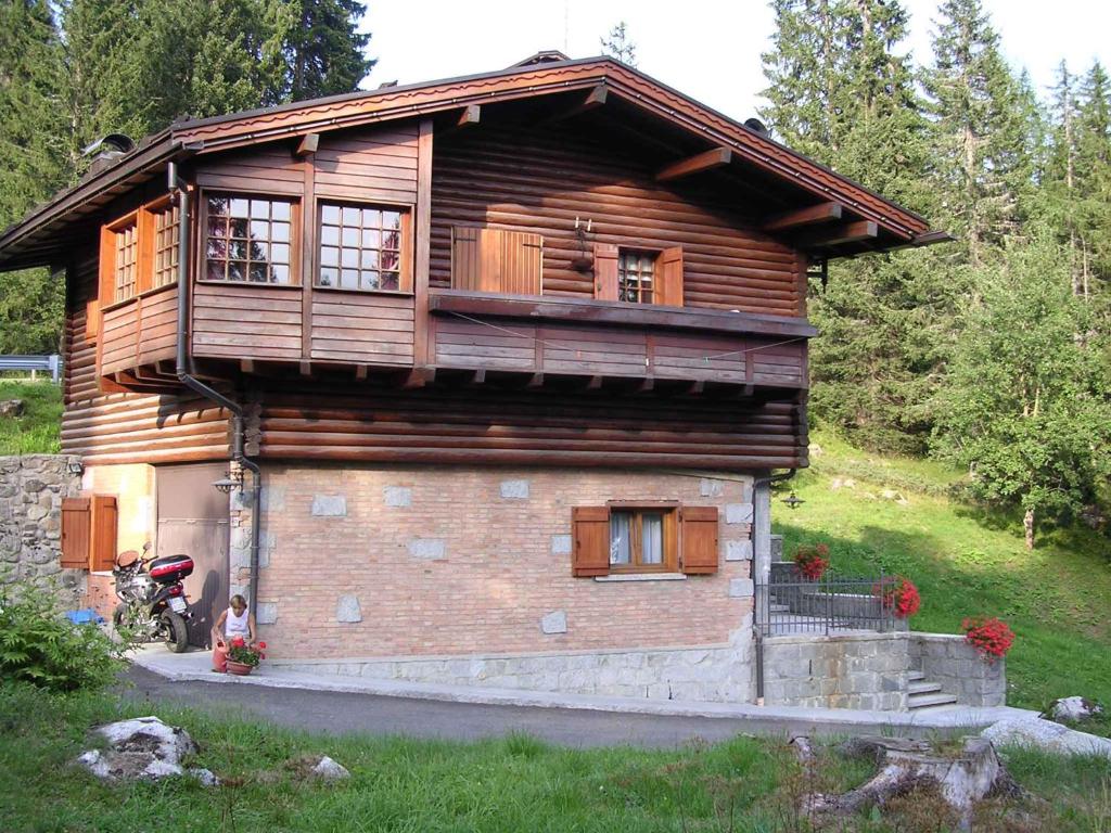 a wooden house with a balcony on top of it at Holiday home in Campo Carlo Magno 24162 in Madonna di Campiglio