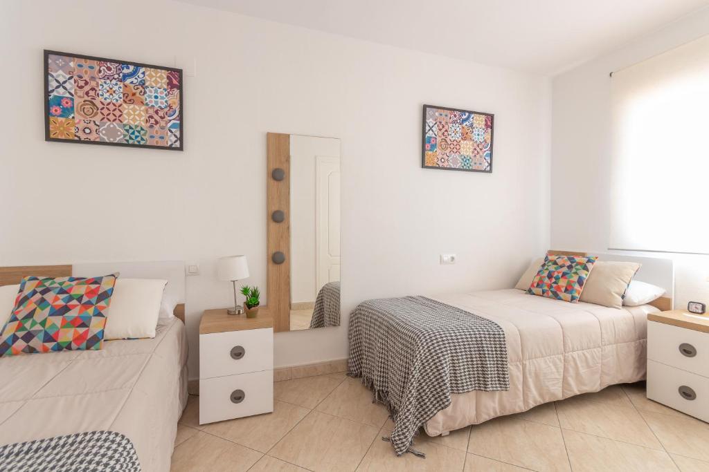 Postel nebo postele na pokoji v ubytování Pondarosa Penthouse 55 - Costa CarpeDiem