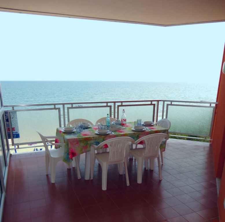 a table and chairs on the balcony of a cruise ship at Apartment in Porto Santa Margherita 27854 in Porto Santa Margherita di Caorle