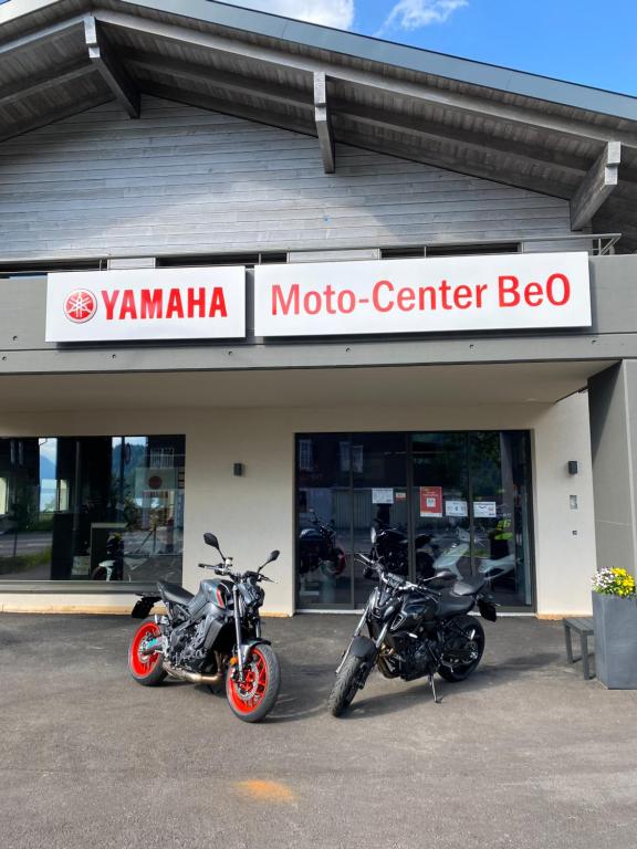 due motocicli parcheggiati di fronte a un centro motoristico di Moto-Center BeO AG (Bike & Bed) a Brienz