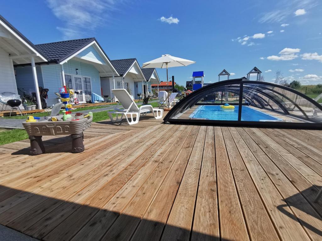 a wooden deck with a pool in a backyard at BobolinLove in Bobolin