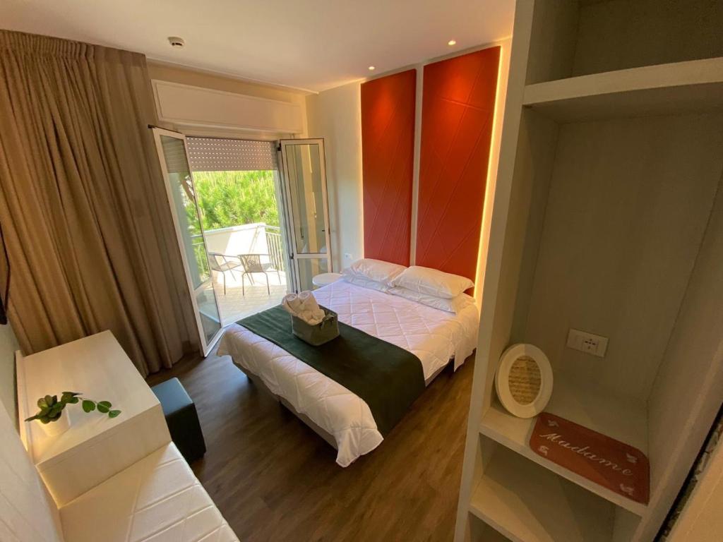 Postel nebo postele na pokoji v ubytování Hotel Loretta & Dependance
